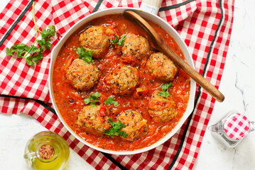 Minced meatballs in tomato sauce in a frying pan.top veiw.selective focus