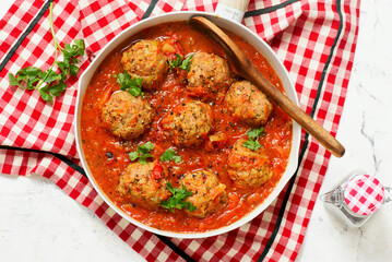 Minced meatballs in tomato sauce in a frying pan.top veiw.selective focus