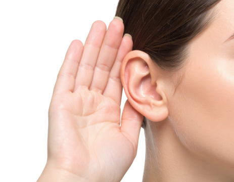 A close-up image of a woman holding her hand behind her ear, as if trying to listen carefully.