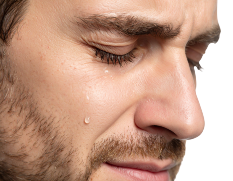 A close-up of a man"s face with tears rolling down his cheek, showing emotion and vulnerability.