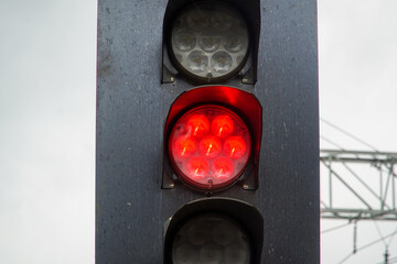 Red light at railway traffic lights. Prohibition of movement. Stop. Concept of constraints.