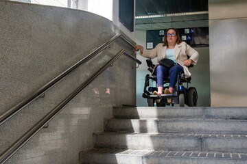 Businesswoman in wheelchair facing architectural barrier in subway station. Concept of inclusion