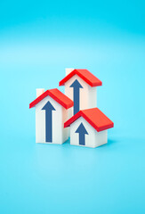 Houses with arrows pointing up. Concept of real estate market growth, price and value. Investment and capital savings in the form of real estate. Rising property demand. Mortgage trends
