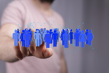 Image depicting a hand interacting with a digital network of diverse people. Ideal for business,...