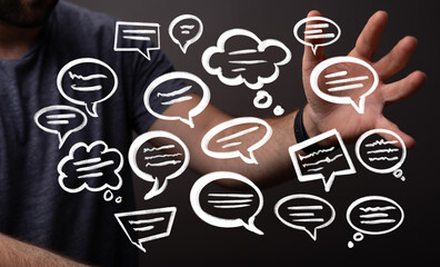 Conceptual image of a man interacting with digital speech bubbles, representing communication,...