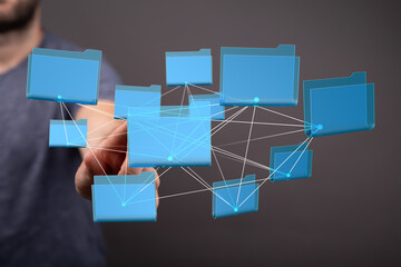 A man interacts with a network of digital files, illustrating data management and connectivity.