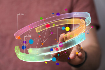 Abstract image of a hand interacting with a colorful 3D data visualization.