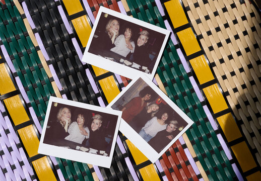 Polaroid mockups rest on a vibrant woven surface, showcasing potential for artistic display or design projects.