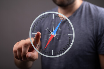 A man interacts with a digital compass interface, symbolizing guidance and strategic planning.