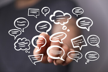 Hand interacting with digital speech bubbles, communication concept.