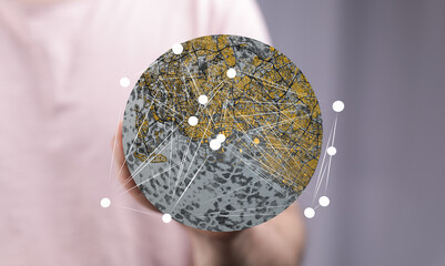 Abstract image of a person holding a global network map, illustrating worldwide connectivity and city infrastructure.