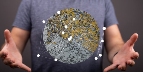 Person holding a digital globe illustrating interconnectedness and global networking.