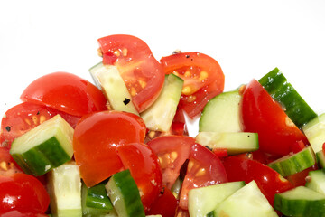 Fresh Salad Tomatoes and cucumber chopped up on white background