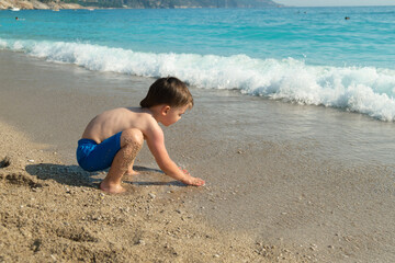 Small child enjoying summer on the seashore