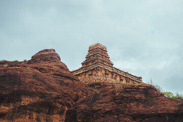 Ancient temple in Badami, Karnataka. The overcast sky adds intensity to the rugged terrain and the...