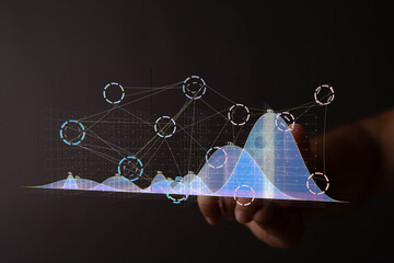 Stock photo of a hand interacting with a digital graph, showing business analytics and growth....