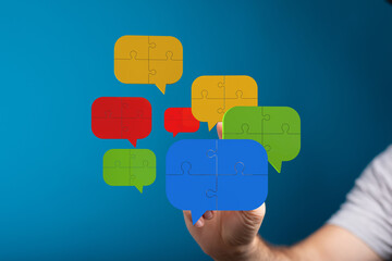 Colorful puzzle pieces forming speech bubbles. Teamwork, ideas, solutions.
