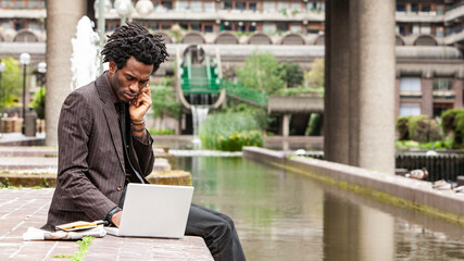 Working Outdoors. A young business professional working out of the office. From a series of images...