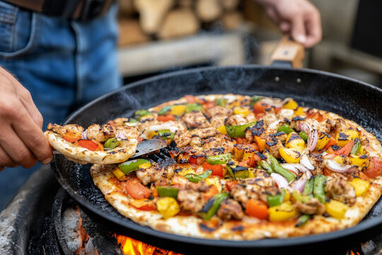 Friends enjoy barbecue in backyard with grilled pizza and vegetables