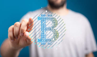 Close-up of a man interacting with a digital Bitcoin symbol, representing cryptocurrency and blockchain technology.