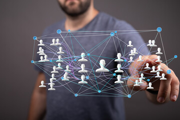 Image of a man interacting with a digital network visualization, showing interconnected people.