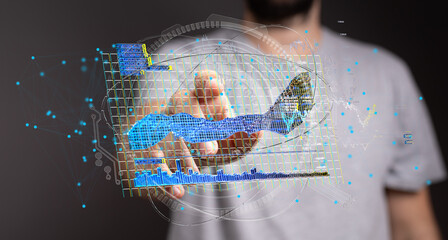 Stock photo of a person interacting with a futuristic holographic display showing data charts and...