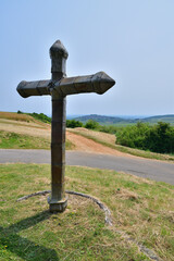 A cross standing on a hill in Sancerre, France, with a distant view of the town. June 9, 2025.