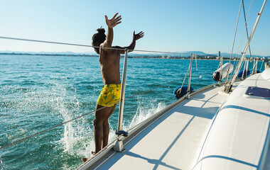 African man jumping inside the ocean during summer vacation - Holidays and travel concept - Main...