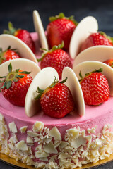 macro shot of pink cake with strawberry topping