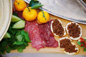 Food on a large served table. a variety of treats and snacks.