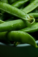 Juicy green peas close up on a plate macro texture