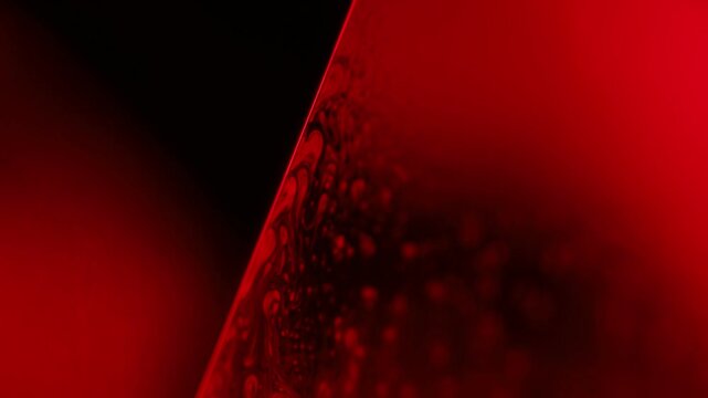 Red and black horror liquid background, bubbles in macro, connection of bubbles in macro, water surface, biological cell structure, liquid cells