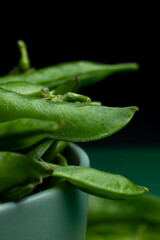 Juicy green peas close up on a plate macro texture