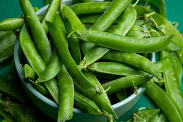 Juicy green peas close up on a plate macro texture