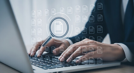 Businessperson searching documents on laptop screen with magnifying glass symbol for data analysis