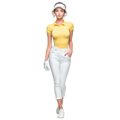 Elegant female golfer in yellow polo shirt and white pants walking confidently, wearing visor and golf glove, full body length, outdoor sports fashion style