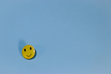 yellow smiley smiling on a blue background