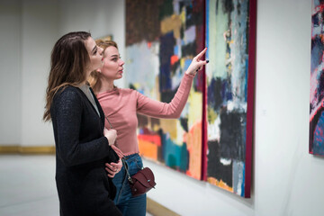 two girls discuss paintings in Gallery of modern art
