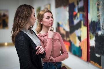 two girls discuss paintings in Gallery of contemporary art © Albert