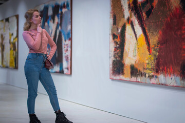the girl stares at the picture in the Gallery of modern art