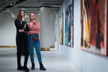 two girls discuss paintings in Gallery of modern art