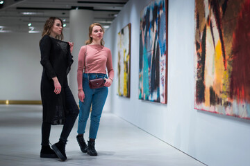 two girls discuss paintings in Gallery of modern art