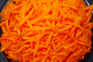 a large bowl of grated carrots.