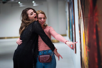 two girls discuss paintings in Gallery of modern art