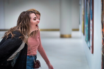 two girls discuss paintings in Gallery of modern art