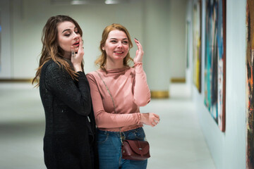 two girls discuss paintings in Gallery of modern art