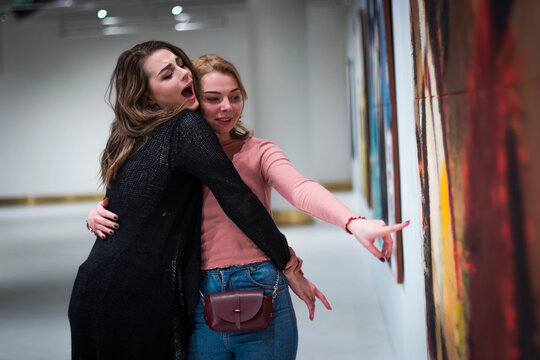 two girls discuss paintings in Gallery of modern art