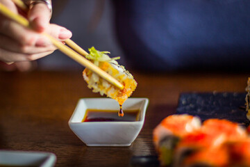 Girl eats Japanese vegetarian rolls