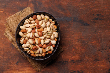A vibrant assortment of various nuts, including almonds, walnuts, hazelnuts, cashews, and pistachios