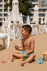 Laughing Boy Playing in the Sand on the Beach